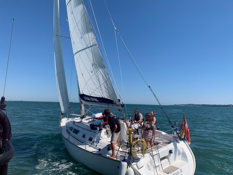 Crew on a sailing yacht during a practical sailing course