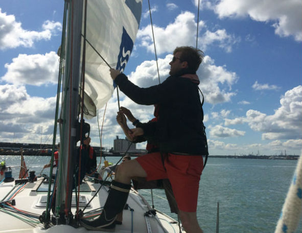 Image of Competent Crew hoisting the sail