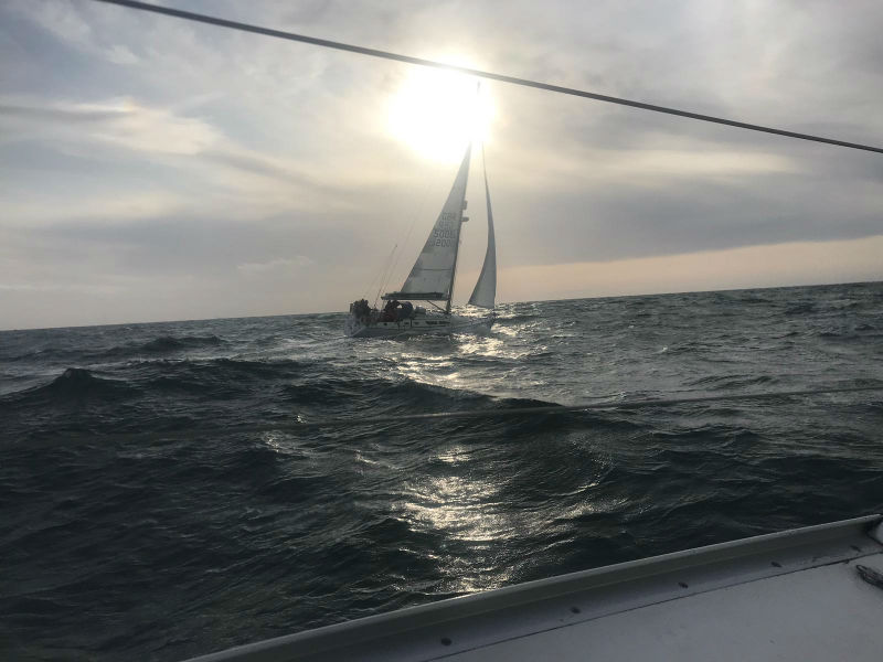 Photo of Menai III coming back across the channel with sun behind the clouds